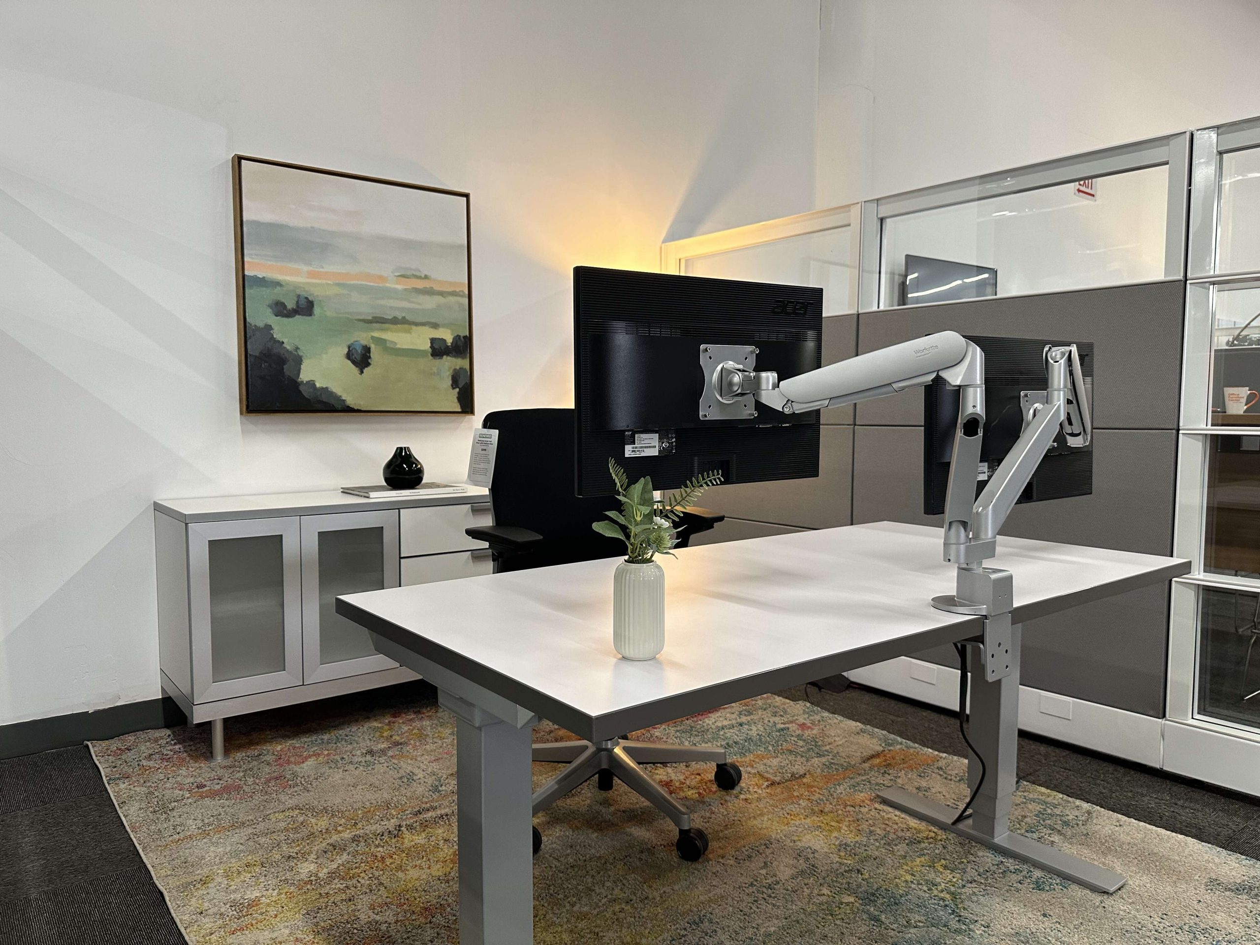 ergonomic Office setup with sit-stand desk and Steelcase Amia displayed in a vignette