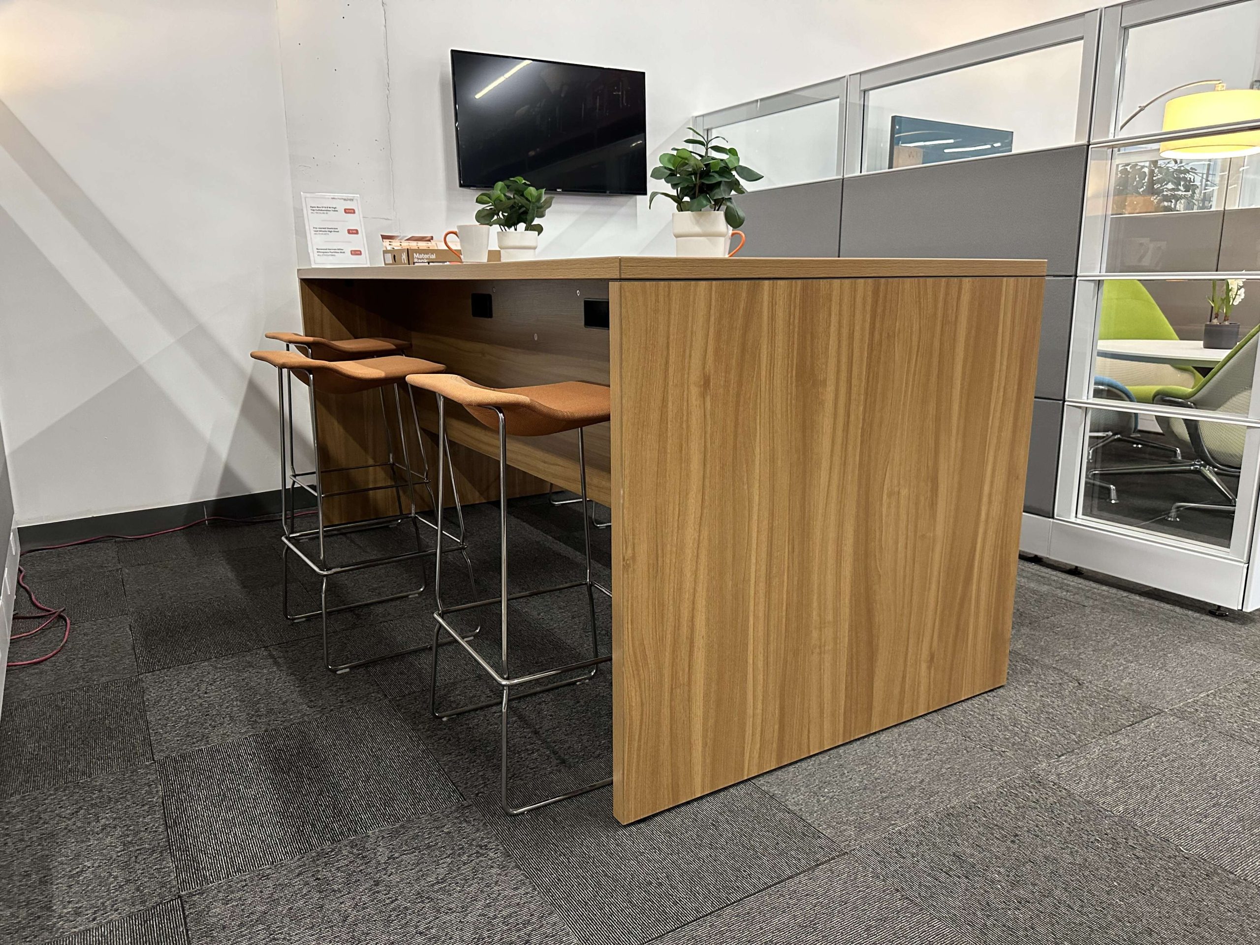 Collaboration table with bar-height stools displayed in a vignette